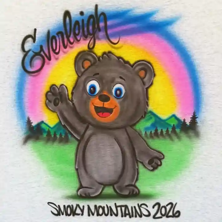 An airbrushed design featuring a cartoon black bear waving, with a colorful rainbow, green hills, pine trees, the name 'Everleigh' in black script, and 'SMOKY MOUNTAINS 2026' at the bottom.