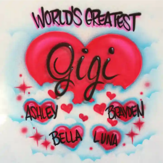 A graphic featuring a large red heart in the center with the name 'Gigi' written across it in black script. The top reads 'WORLD'S GREATEST' in black with pink outline, and smaller names 'ASHLEY', 'BRAYDEN', 'BELLA', and 'LUNA' are placed around smaller red hearts and sparkles.