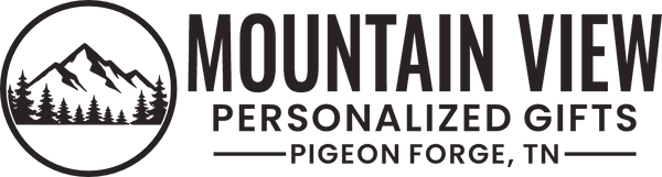 A black and white logo for Mountain View Personalized Gifts, featuring a circular mountain and pine tree emblem on the left, with the text 'MOUNTAIN VIEW PERSONALIZED GIFTS' and 'PIGEON FORGE, TN' on the right.
